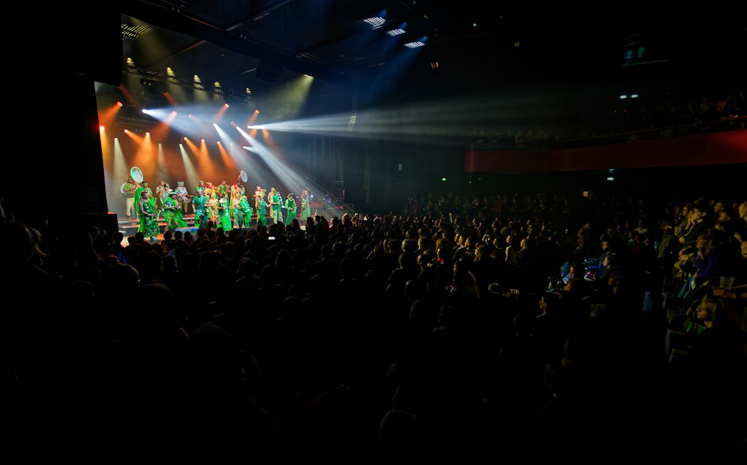 Live entertainment show set with stage lights and audience seating