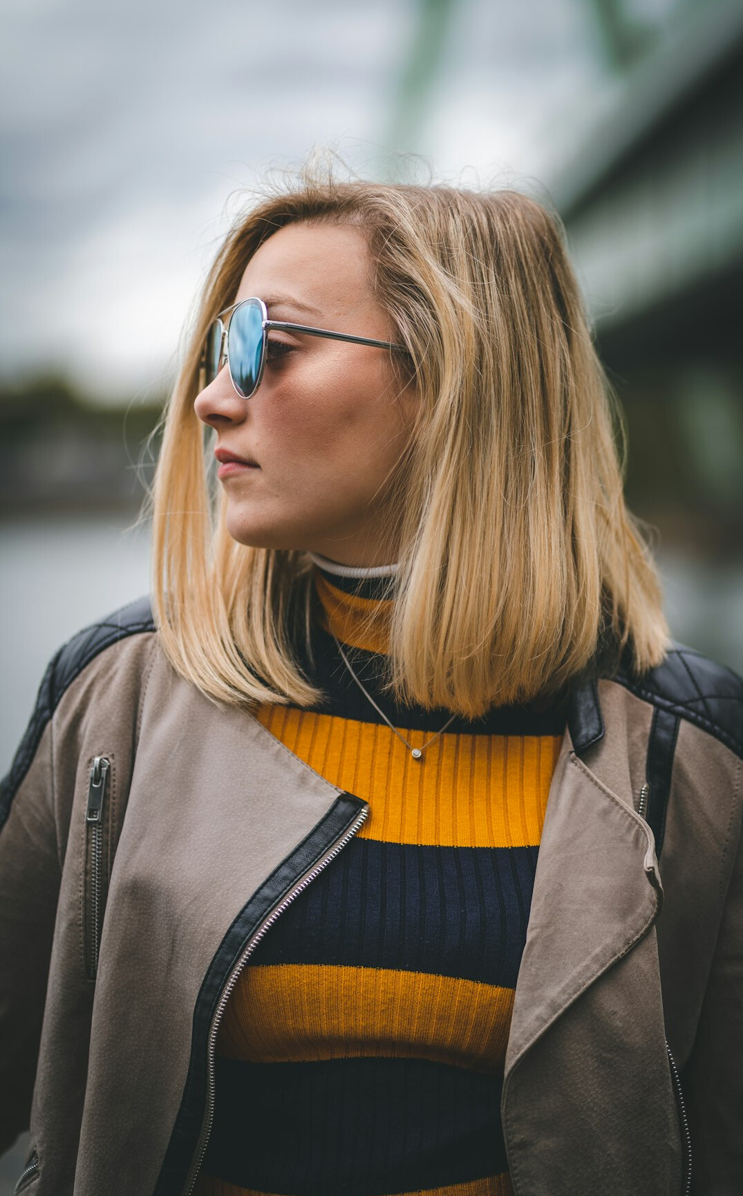 Portrait of a white British woman in her early fifties with a short blonde bob wearing glasses